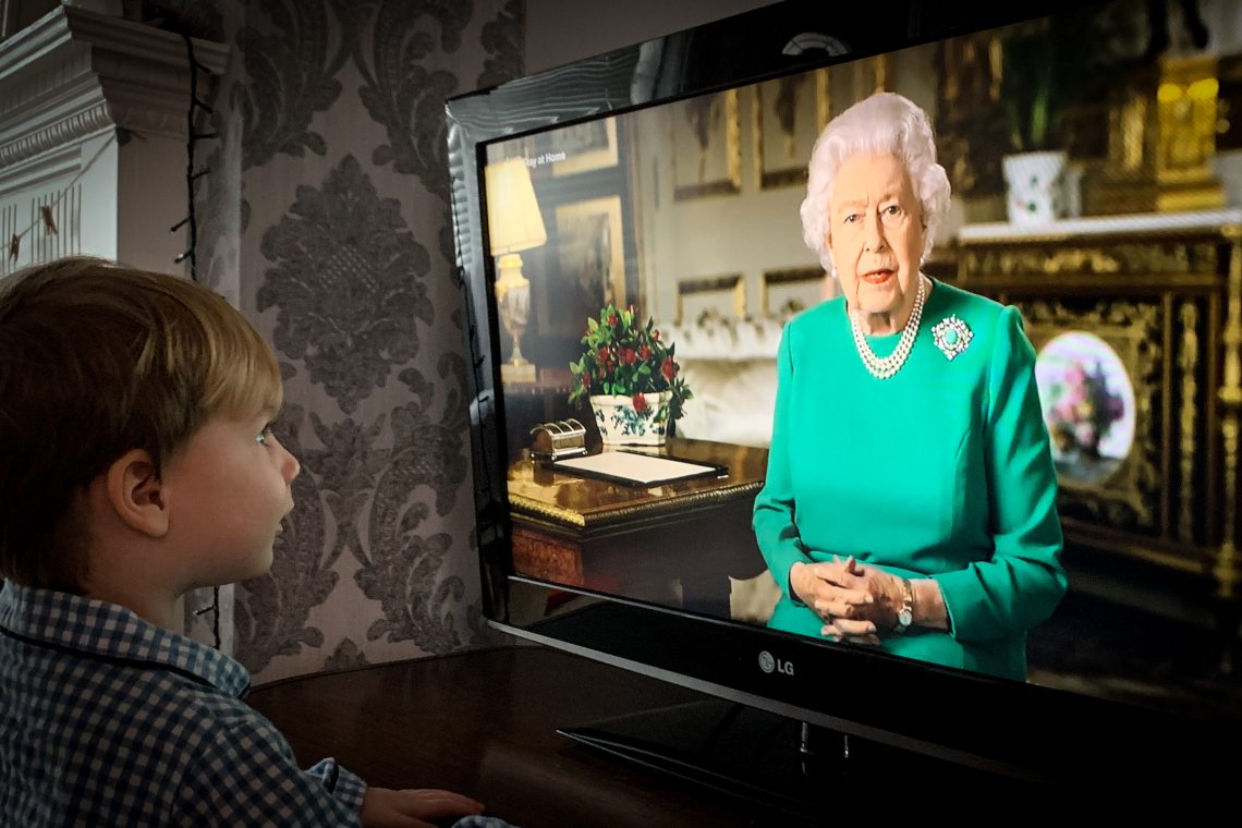 A child watches Queen Elizabeth II giving a speech on television