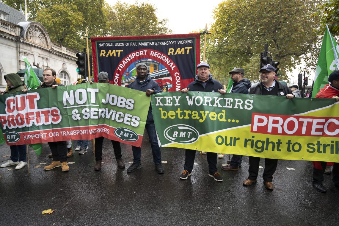Street protesters carrying banners that demand changes in Britain’s economic policies