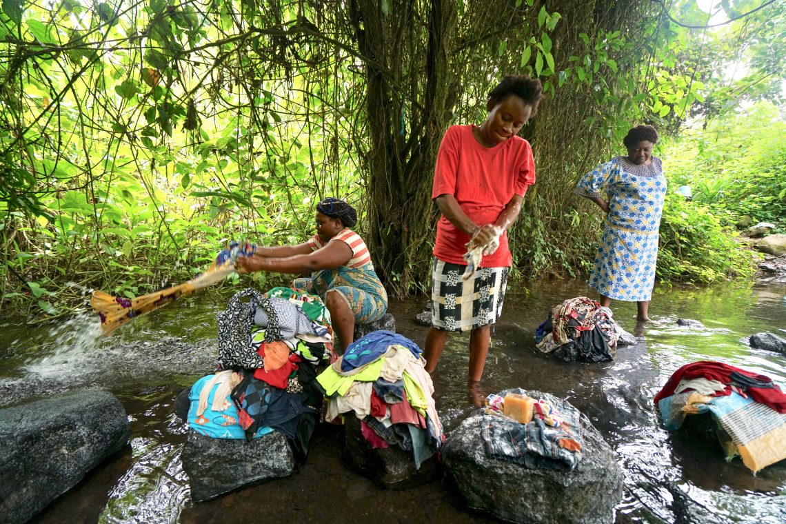 Displaced Cameroonian women washing clothes in the river