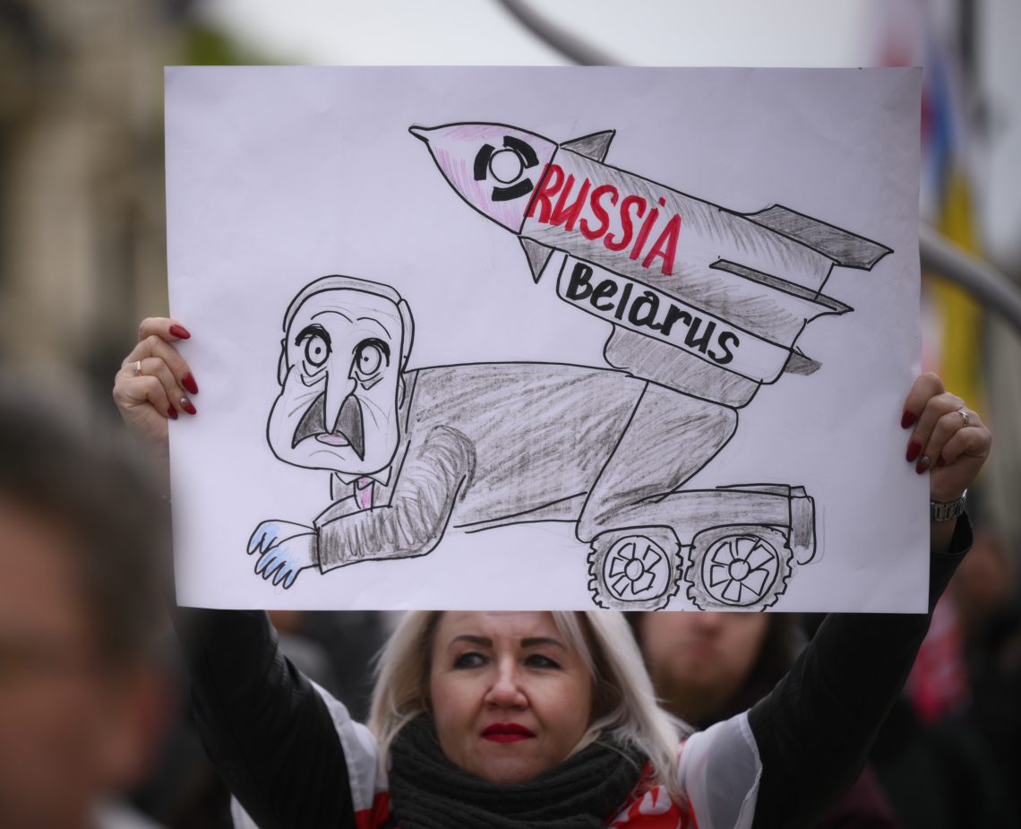 A protester holds a cartoon drawing