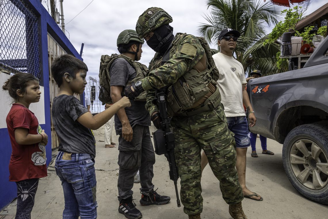 Soldier fist bumps a child in Ecuador