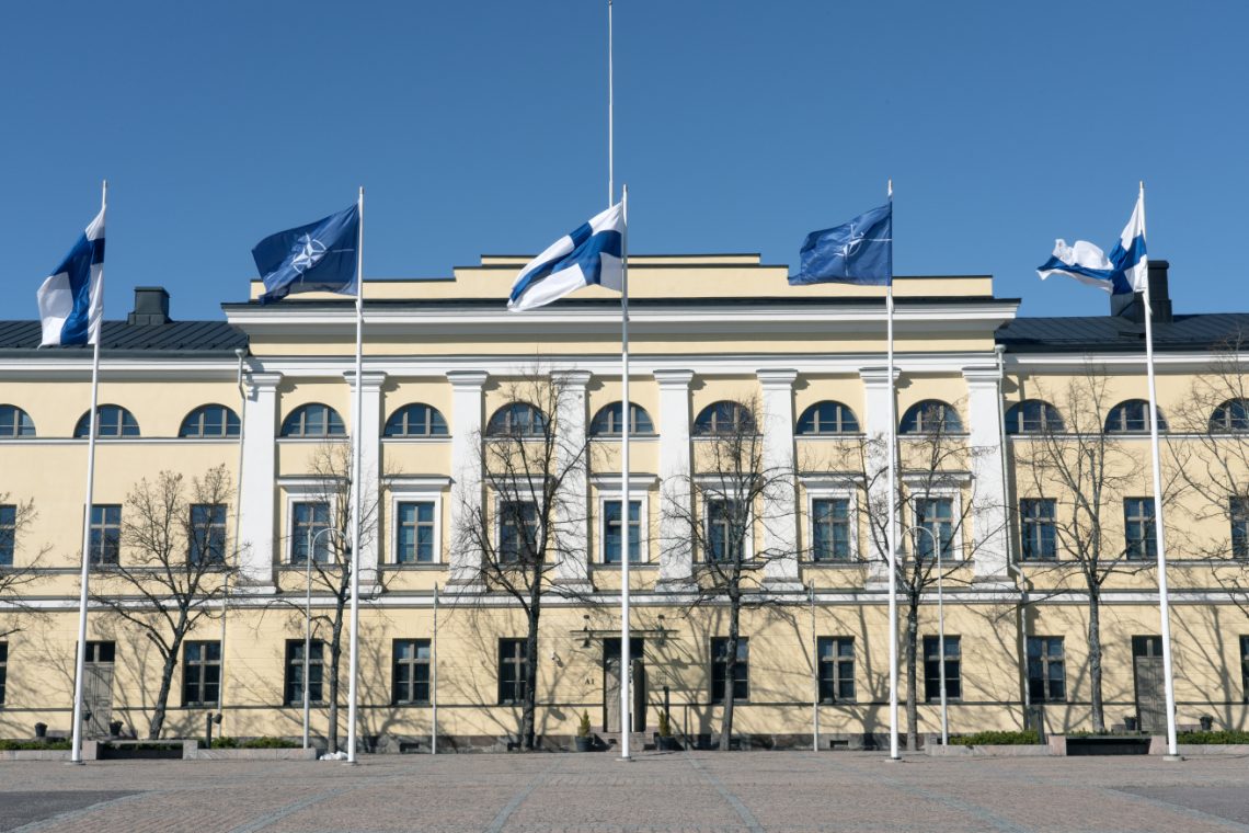 Finnish and NATO flags waving at the Finnish foreign ministry building.
