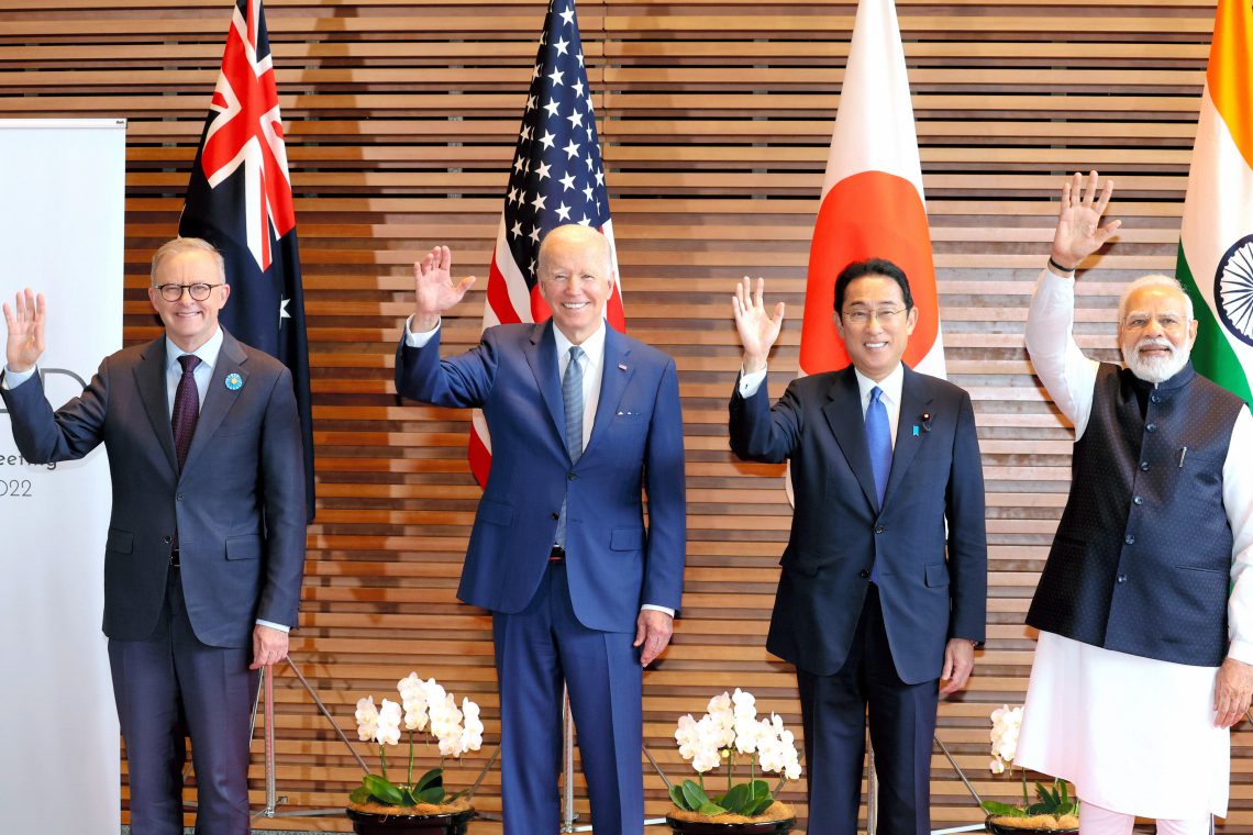 Leaders from Australia, the U.S., Japan and India wave at a meeting in Tokyo.
