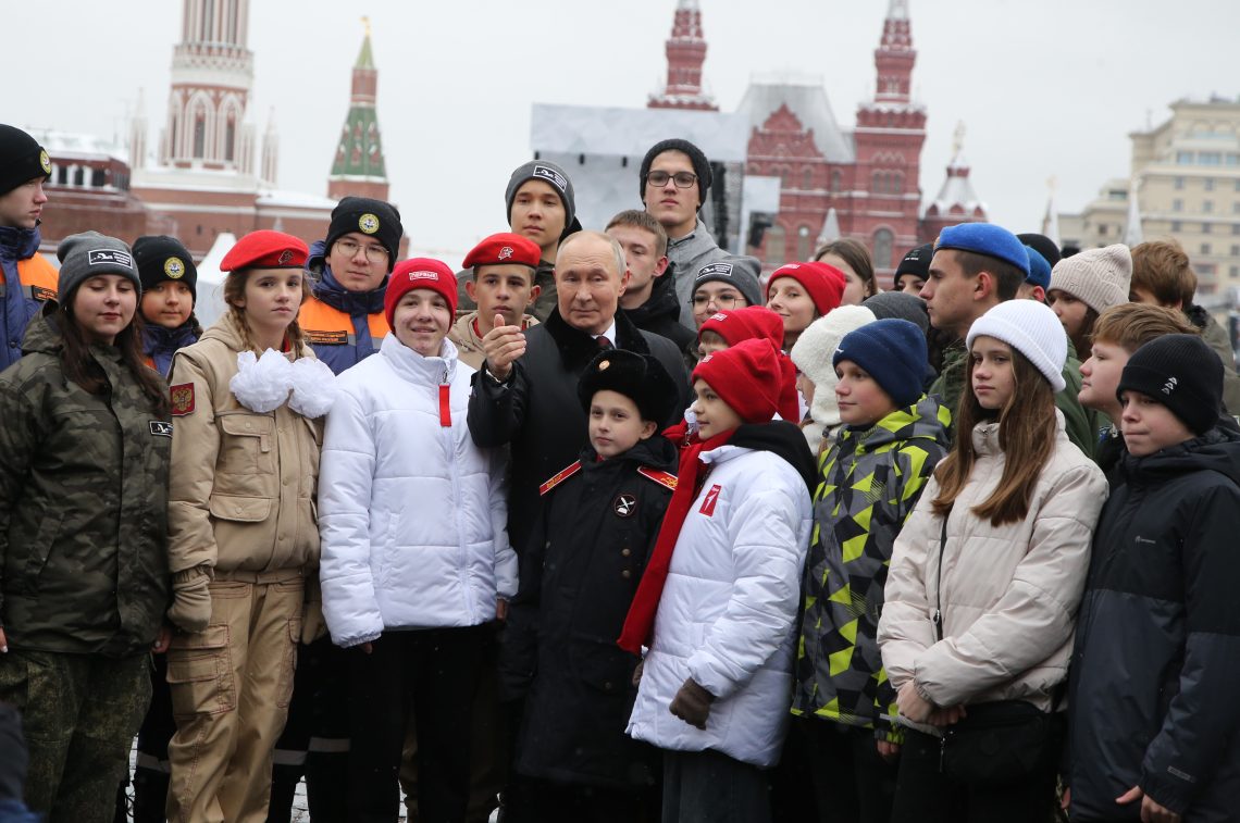 President Vladimir Putin poses with the children of Russian officers involved in the military invasion of Ukraine and participants from youth and student organizations.