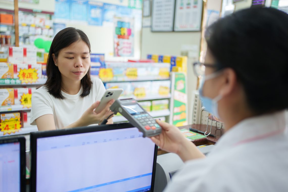 Chinese woman making payment (CBDC)