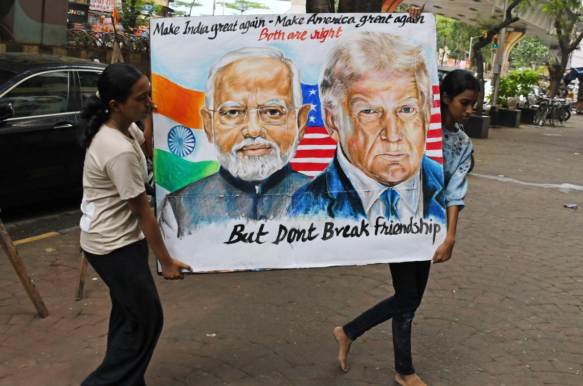Aug. 1, Mumbai, Maharashtra: Students display a poster featuring Indian Prime Minister Narendra Modi alongside U.S. President Donald Trump. 