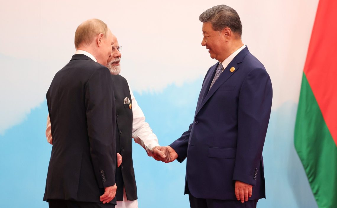Sep. 1: Russian President Vladimir Putin, Chinese President Xi Jinping and Indian Prime Minister Narendra Modi speak to each other before the start of the meeting of the Council of Heads of State of the Shanghai Cooperation Organization in Tianjin, China.
